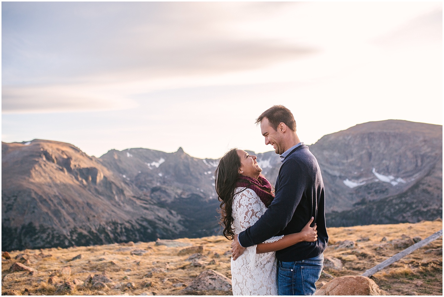 Couple overlooking the views at the top of Trail Ridge Road at sunset for RMNP engagement