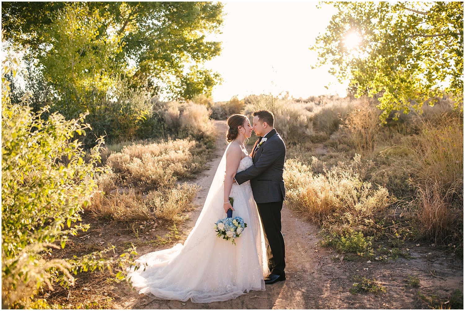 Bride and groom kissing at golden hour for their fall wedding at Prairie Star Restaurant