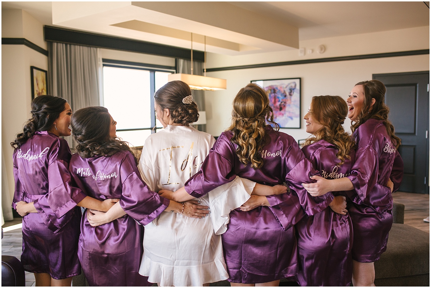 Bride and bridesmaids hanging out in purple robes at Santa Ana Star Casino Hotel