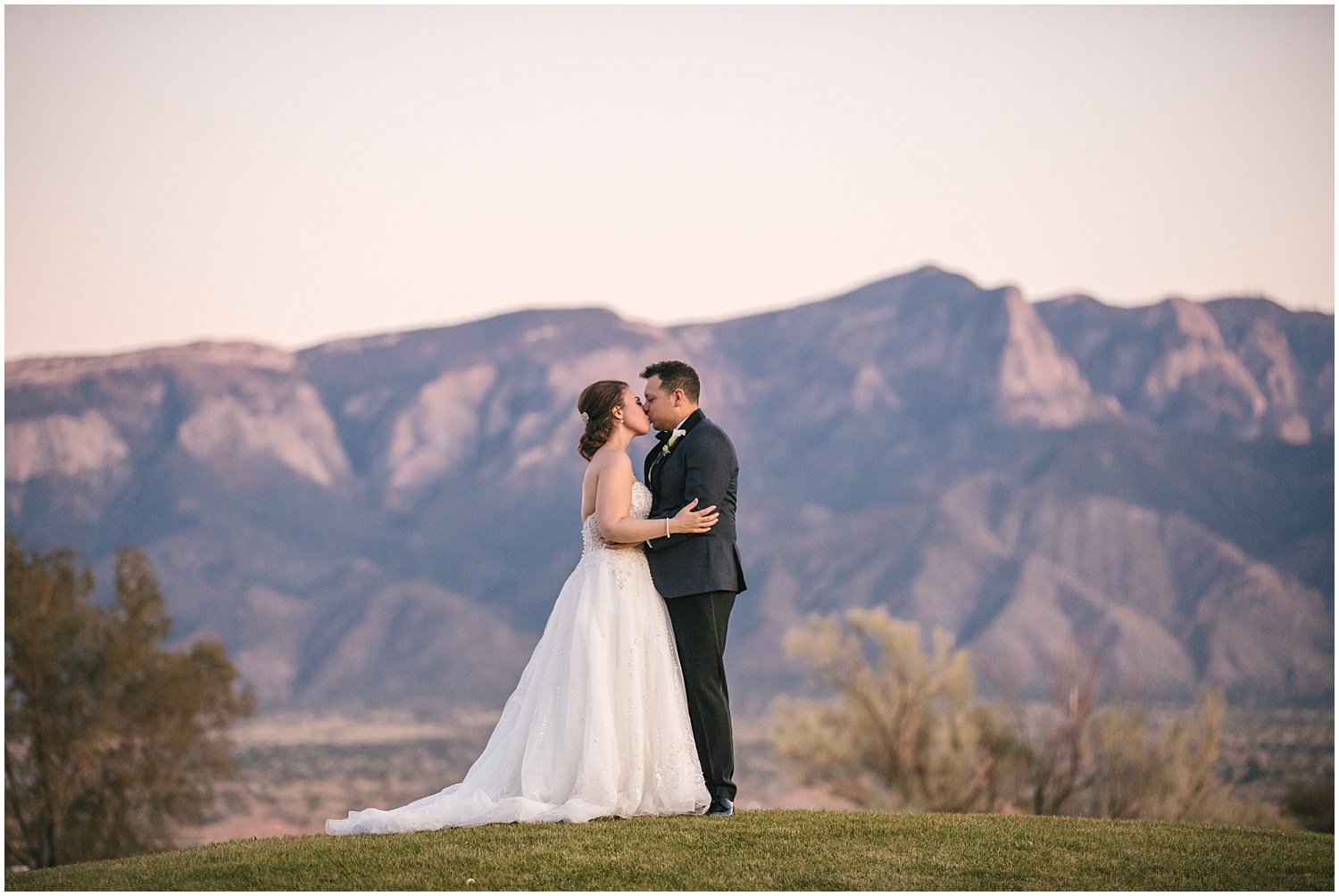Bride and groom sunset portraits with the Sandia Mountains at Prairie Star Restaurant wedding