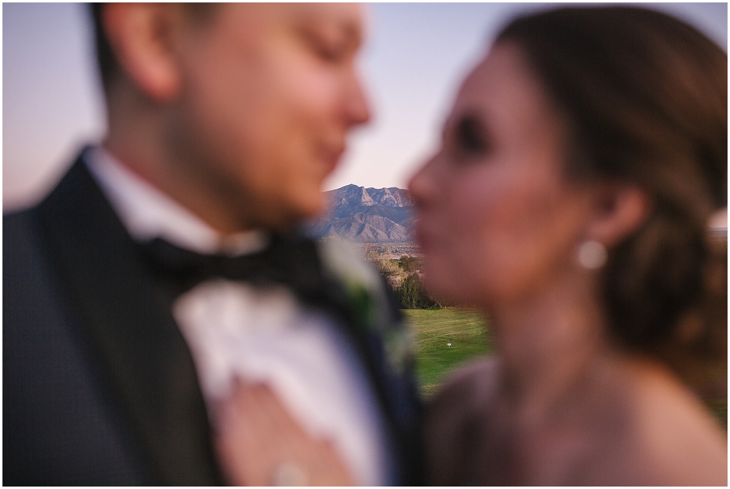 Sandia Mountains behind bride and groom at sunset from Santa Ana Pueblo