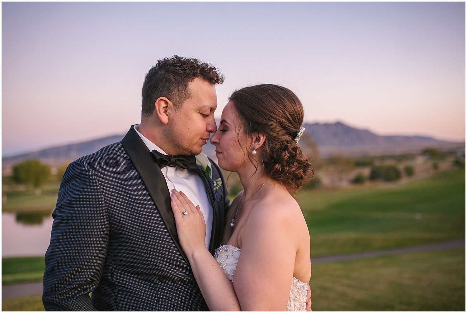 Bride and groom nuzzle noses at sunset for fall wedding at Prairie Star Restaurant