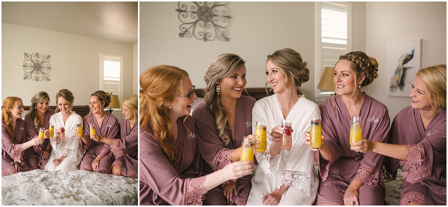 Bridesmaids in robes cheering with mimosas on wedding day