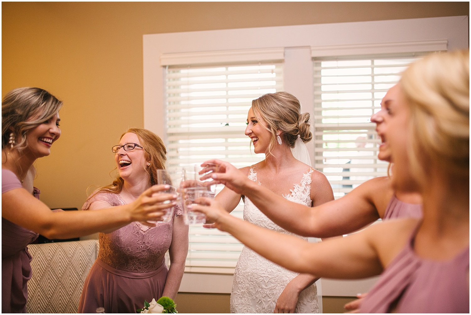 Bridesmaids toast in bridal suite at Cordera as they wait out the summer storms