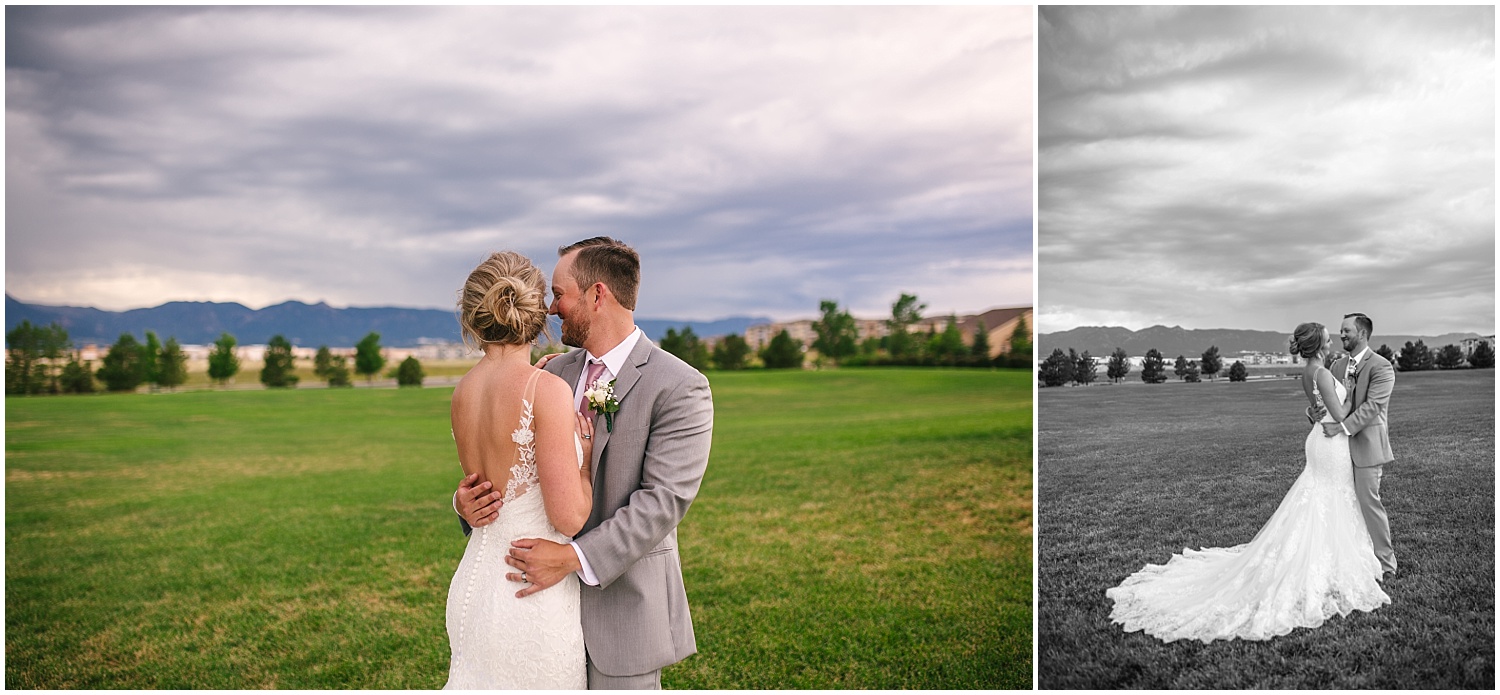 Bride and groom holding each other under storm clouds in Colorado Springs