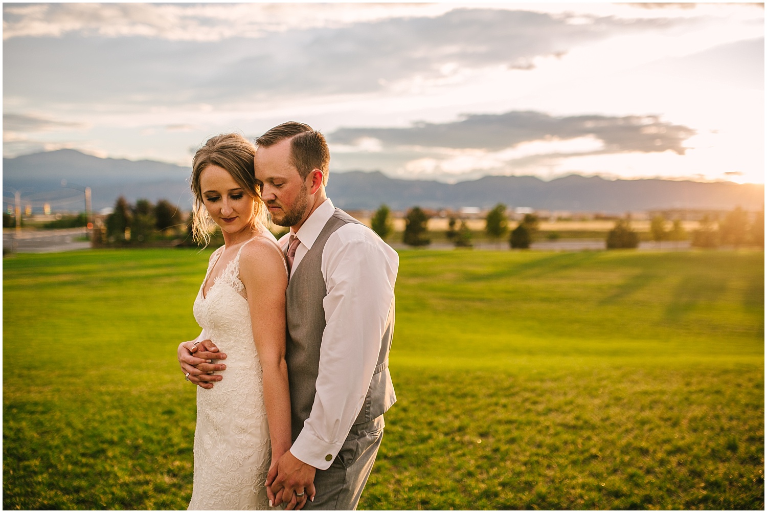Bride and groom embrace at golden hour after thunderstorm in Colorado Springs