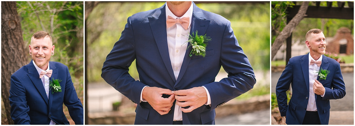 Navy blue suit, pink bow tie, and greenery boutonniere groom details