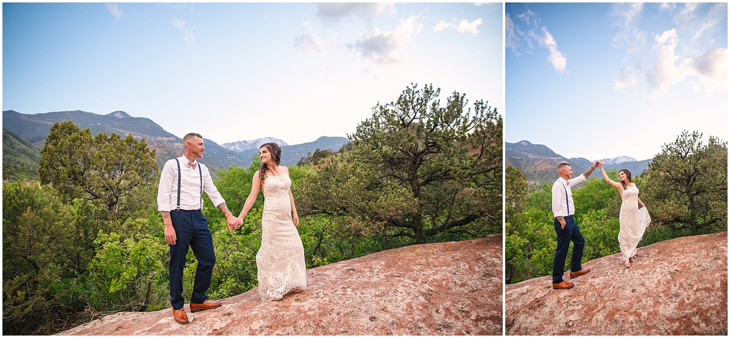 Bride and groom dancing on red rocks overlooking Pikes Peak in Manitou Springs
