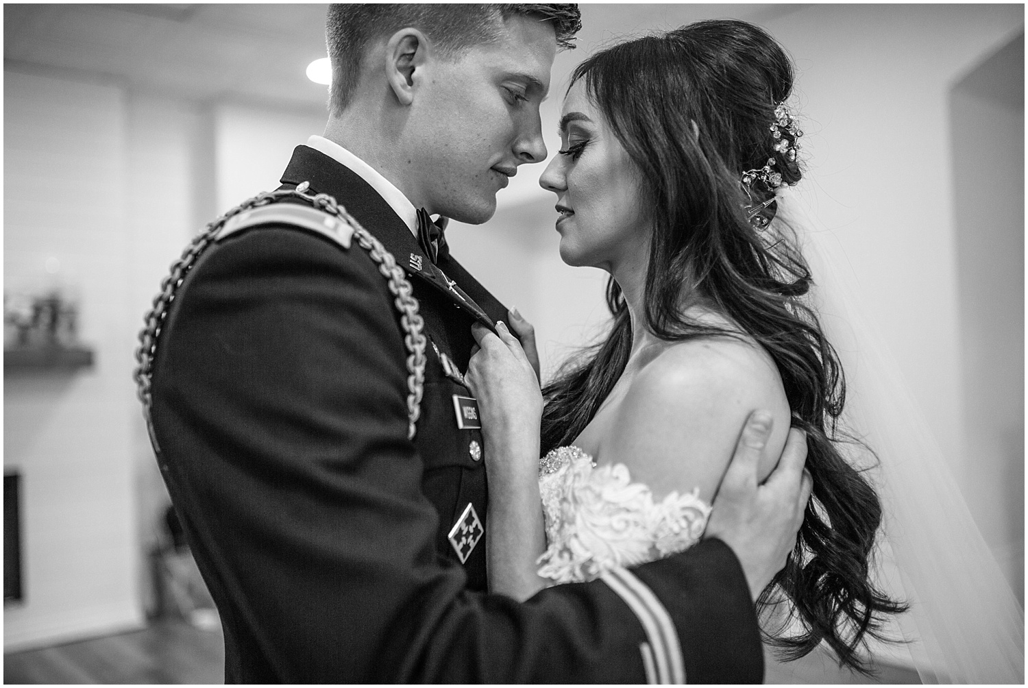 Romantic b&w portrait of bride and groom at military wedding