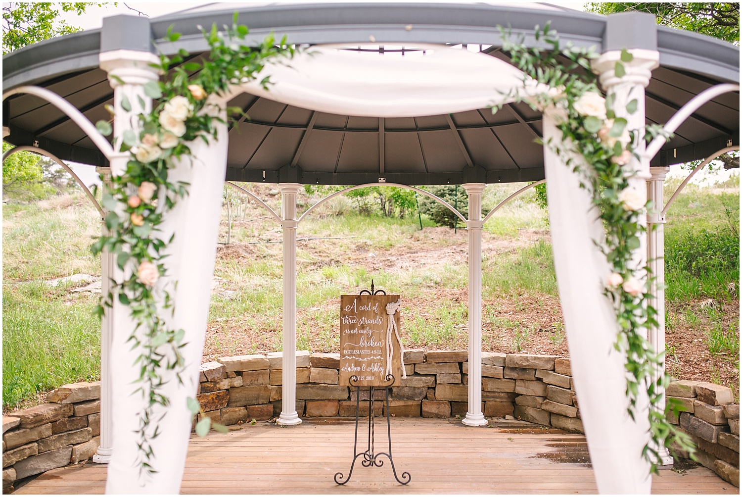Creekside Event Center wedding ceremony gazebo with white drapery and lots of greenery