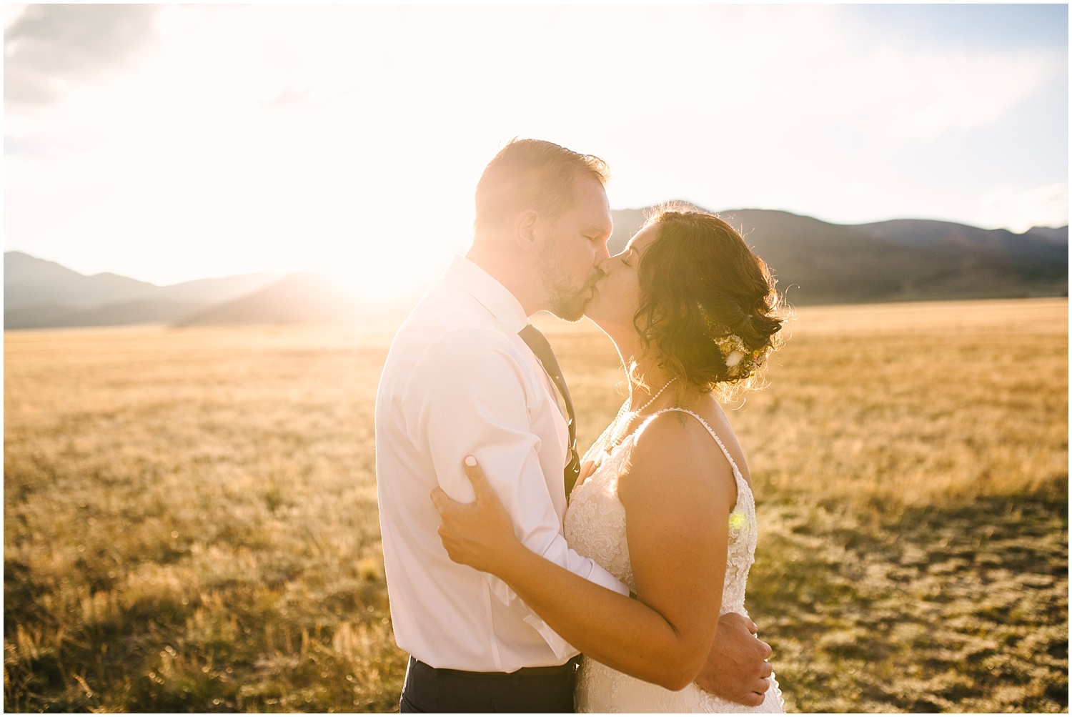 Bride and groom kissing at golden hour in the mountains near Fairplay Colorado