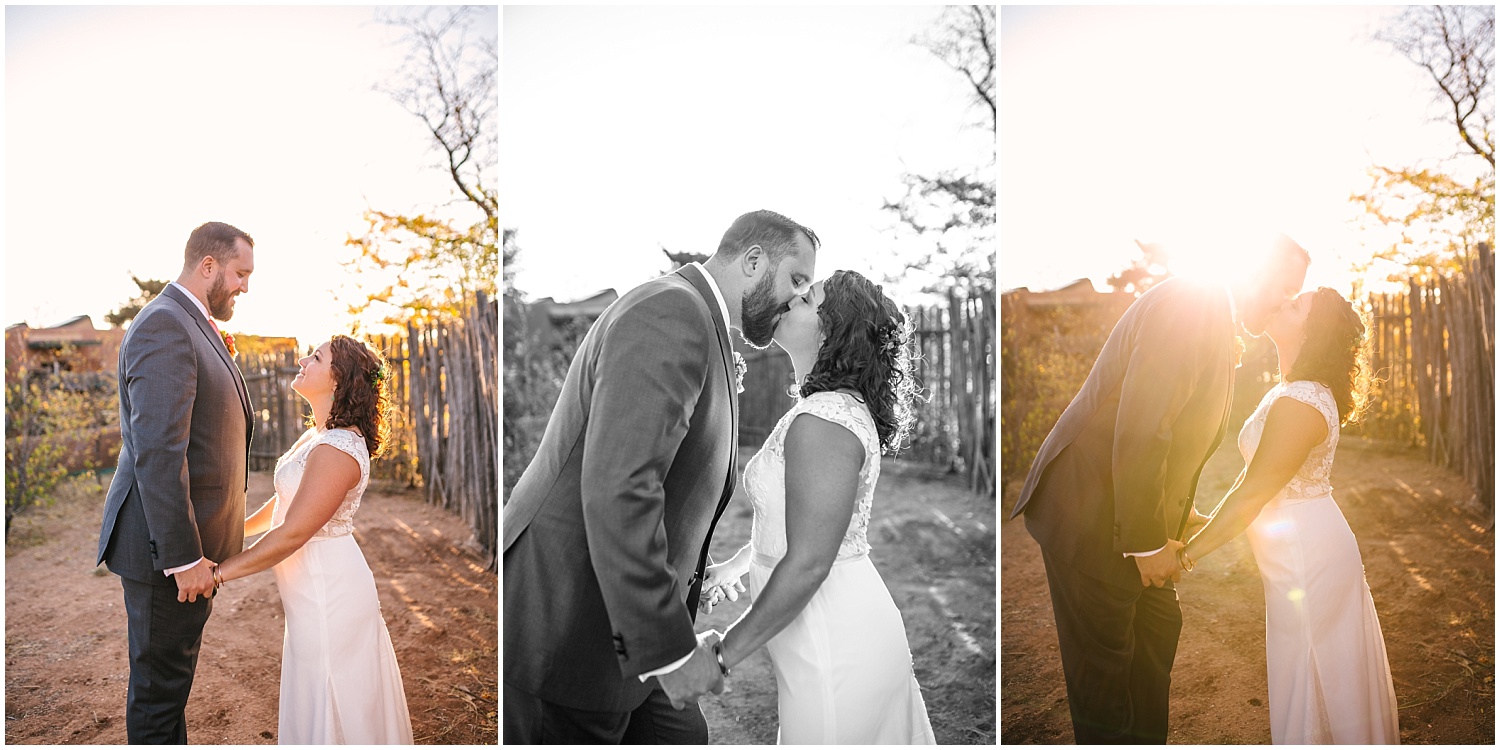 groom leans down to kiss bride at sunset