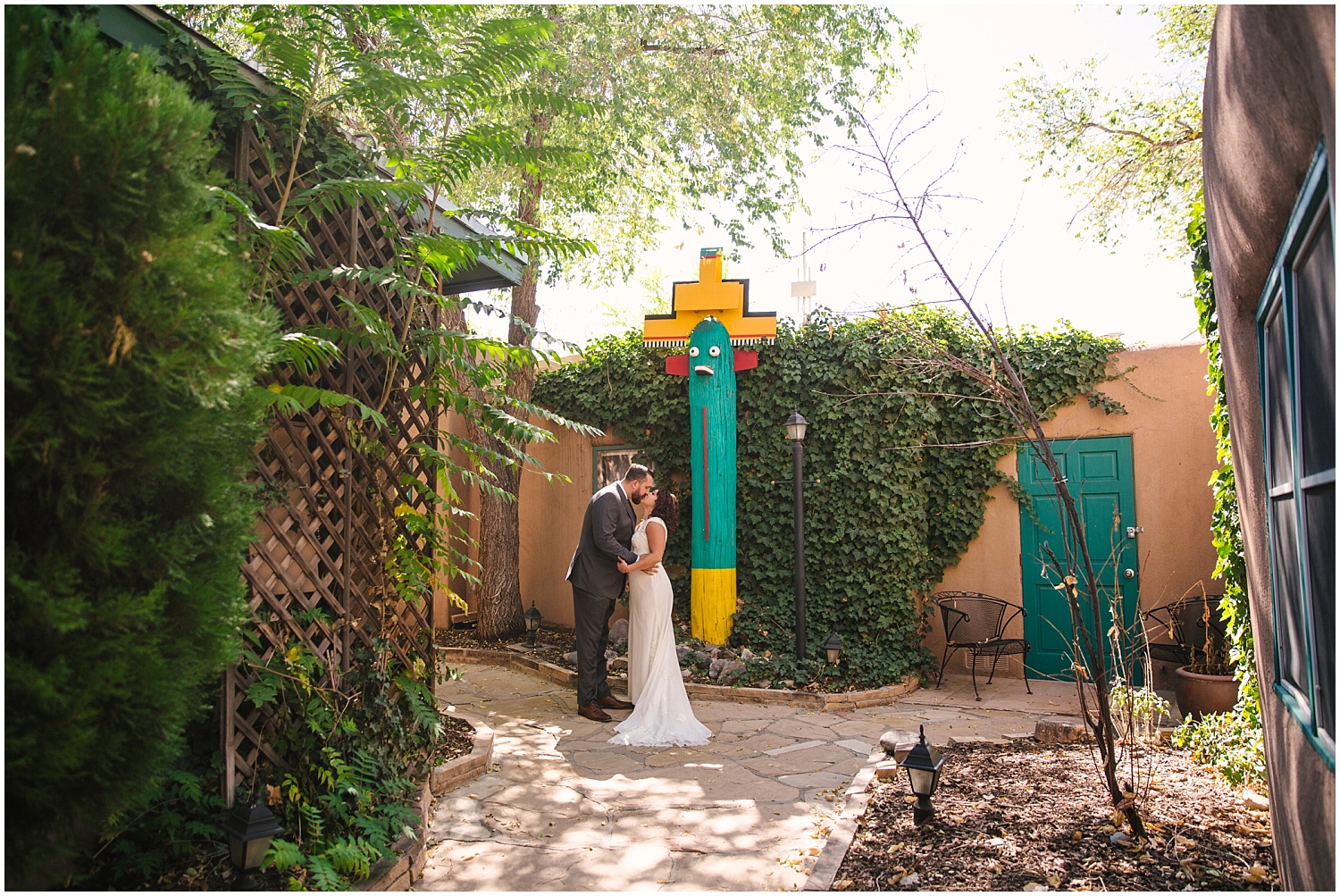 Bride and groom kissing outside the casitas at Las Palomas Hotel before their wedding in Santa Fe