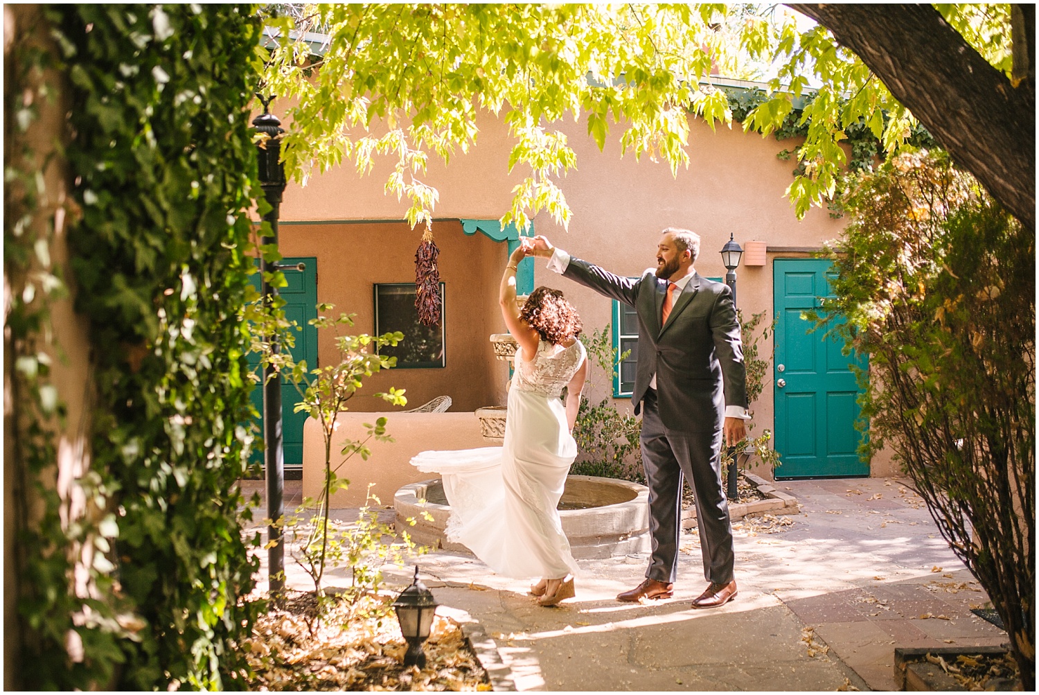 Bride and groom dance around the water fountain at Las Palomas Hotel in Santa Fe New Mexico