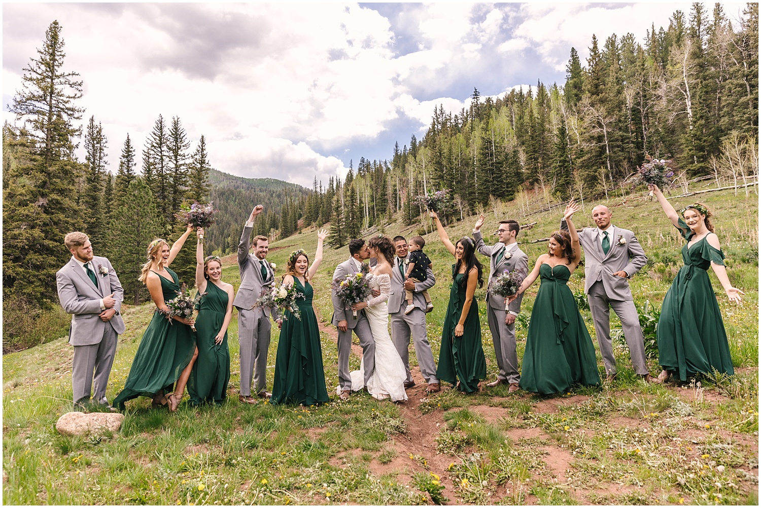 Bridesmaids in forest green dresses and groomsmen in light gray suits for mountain wedding near Telluride