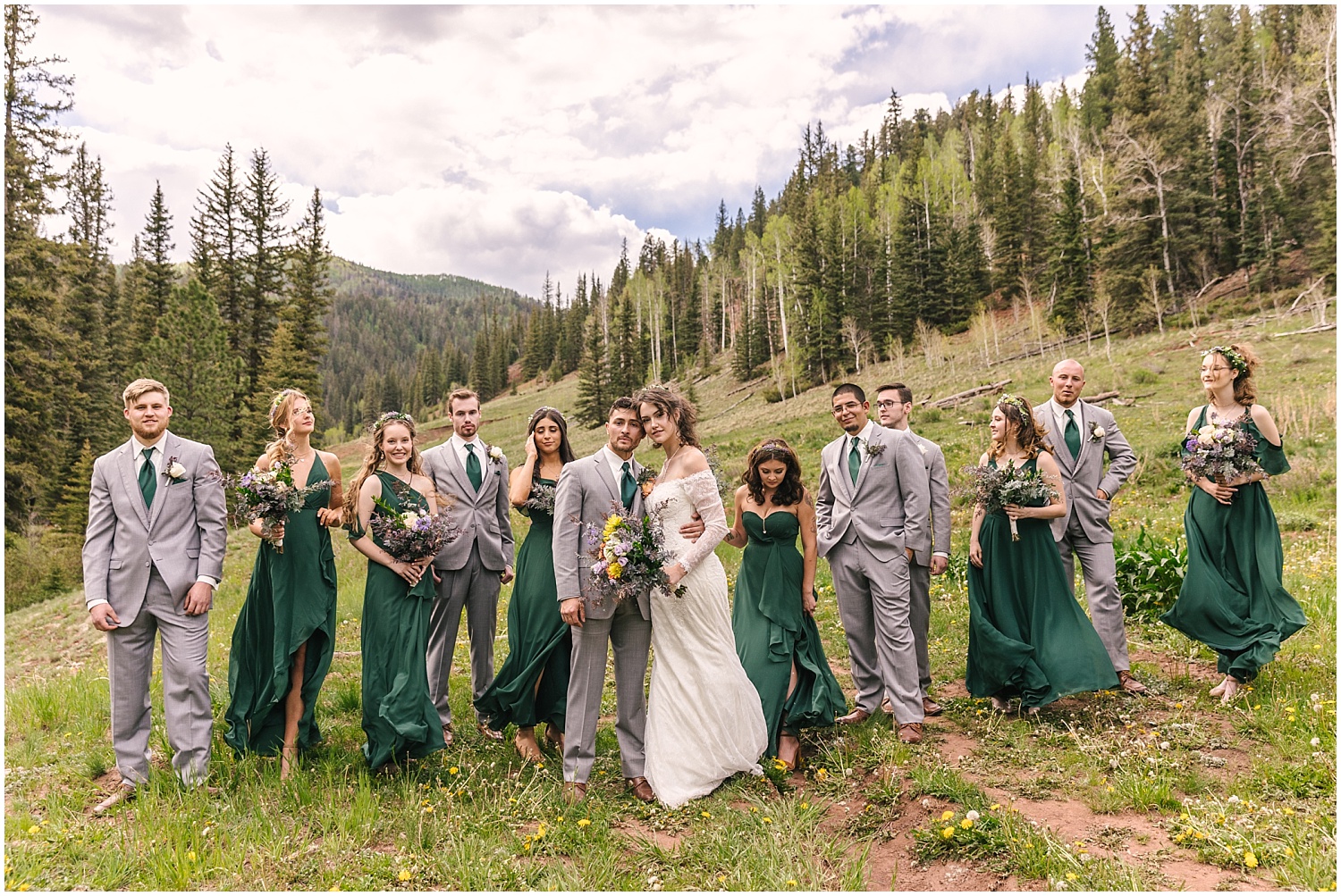 Bridesmaids in forest green dresses and groomsmen in light gray suits for mountain wedding near Telluride