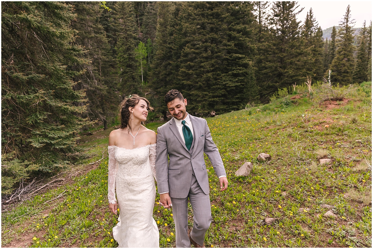 Bride and groom walking through the fields at their Telluride wedding