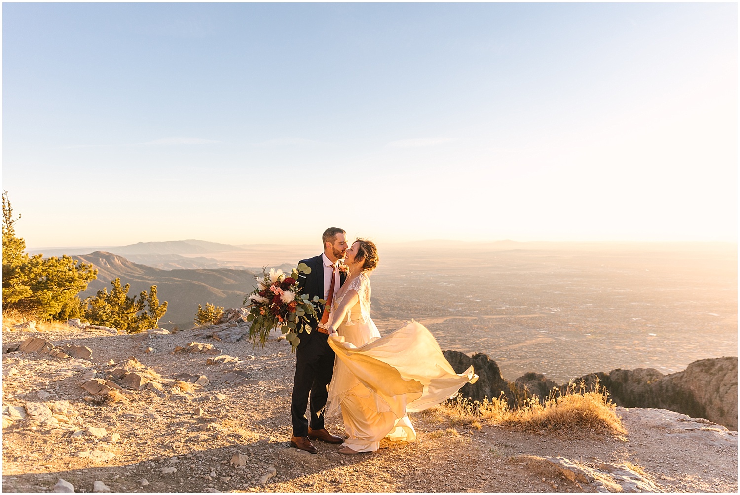 Bride and groom kissing at sunset on Sandia Crest