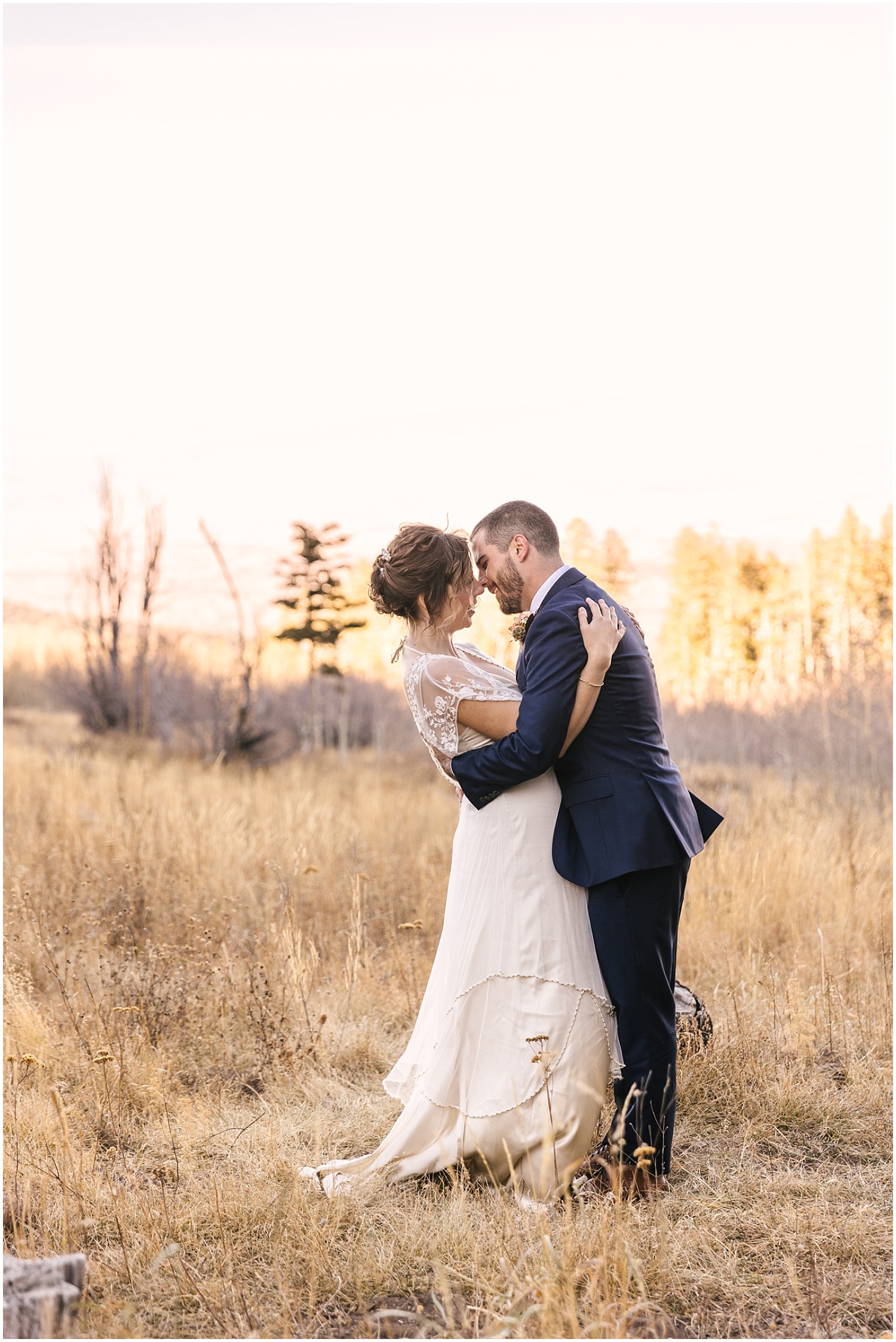Bride and groom first kiss at winter elopement in Sandia Mountains