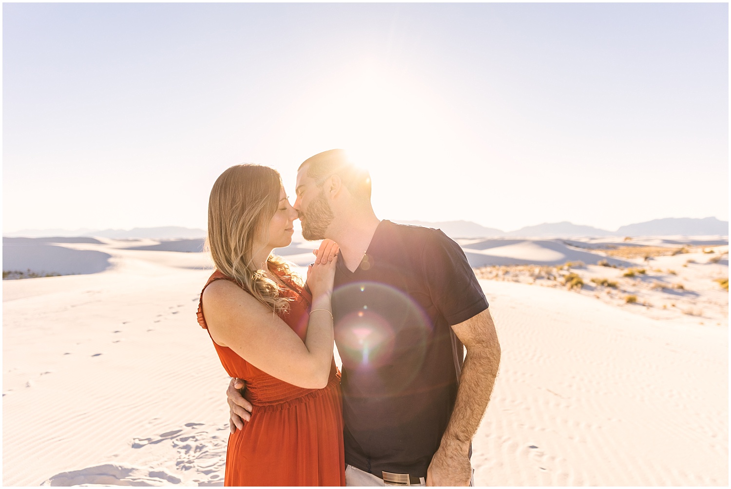 Couple kissing at golden hour in White Sands engagement session
