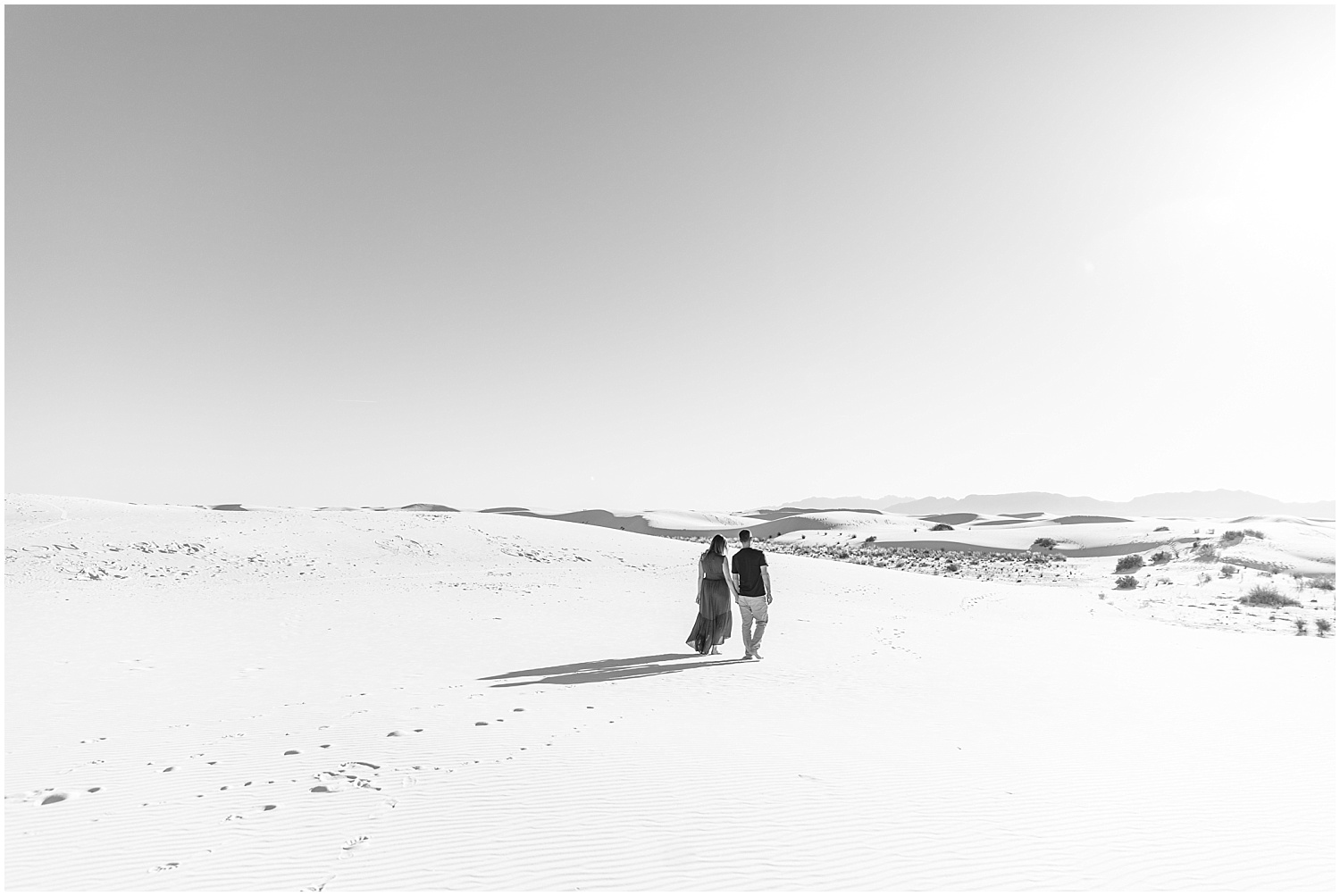 Black and white couple walking at White Sands New Mexico