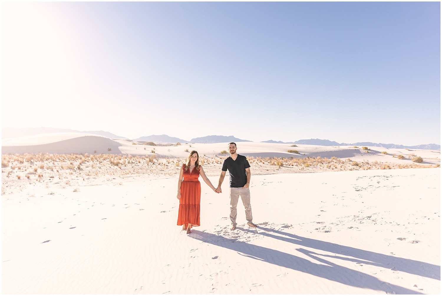 Couple holding hands at White Sands engagement session