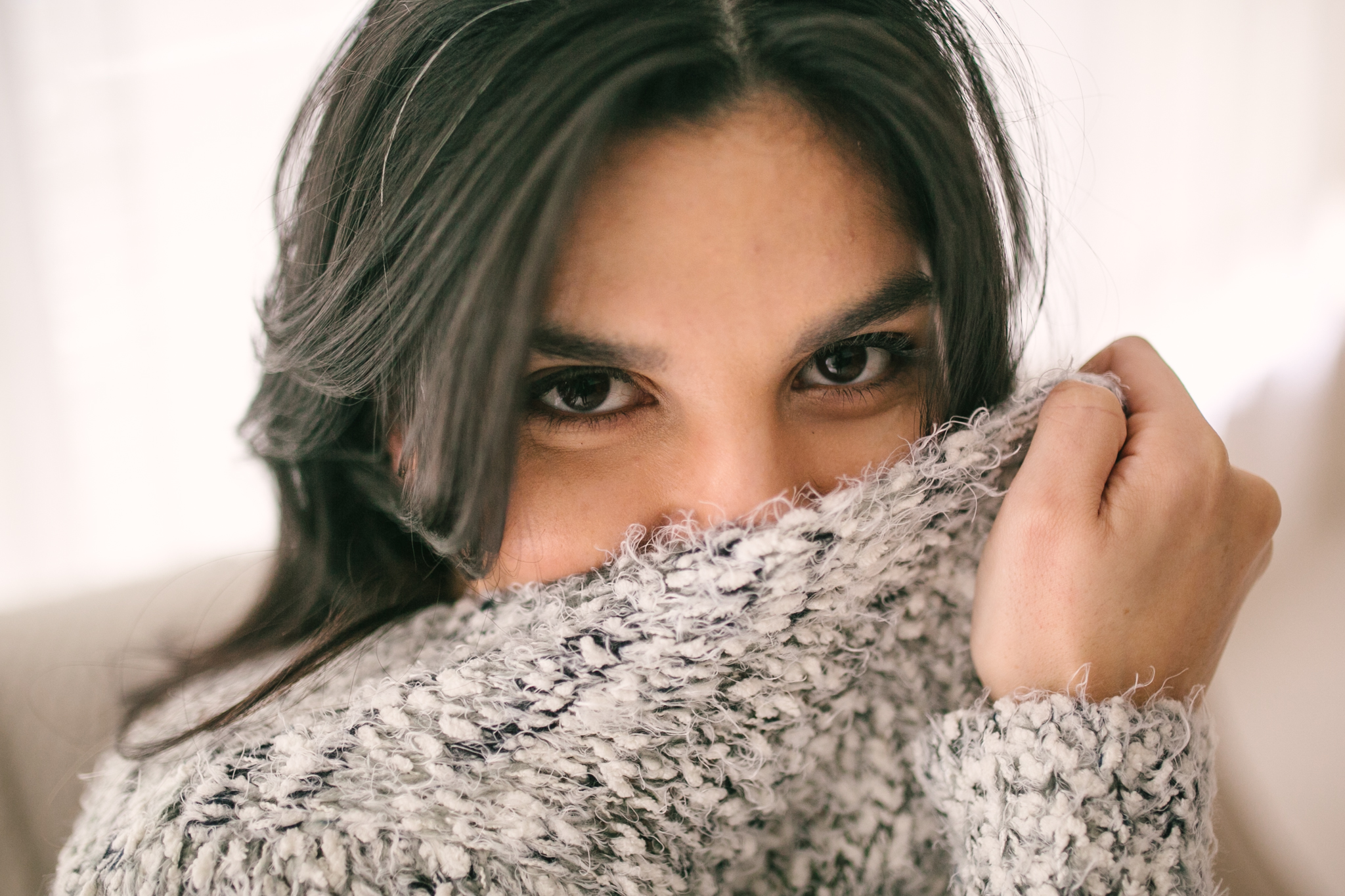 Peeking out from sweater headshot at boudoir photo session