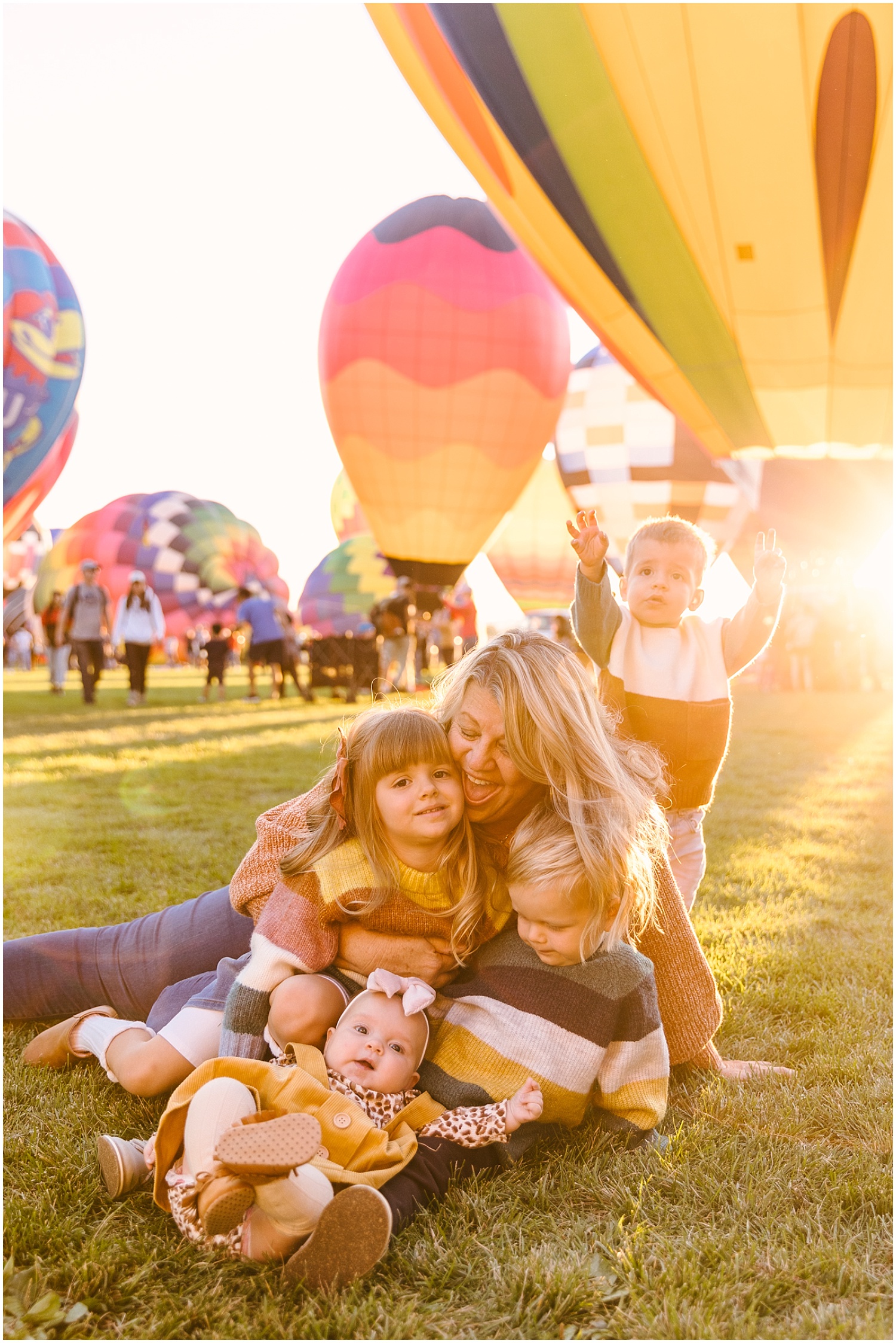 Cute portrait of grandma with grandkids at golden hour during Albuquerque Balloon FIesta Glow