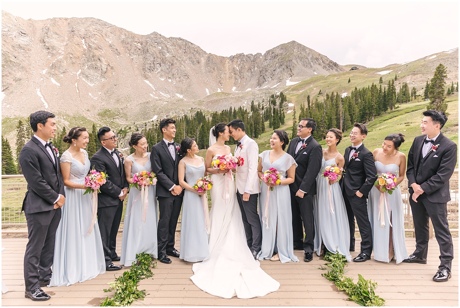 wedding party in black suits and baby blue dresses with pink bouquets by A florae at Black Mountain Lodge Arapahoe Basin Colorado