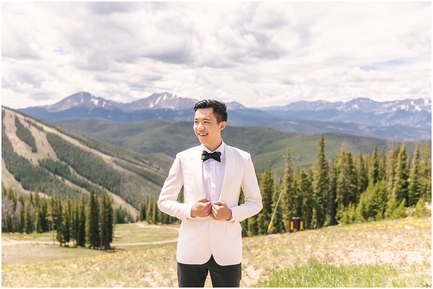 groom's portrait in white suit at Keystone Summit Colorado