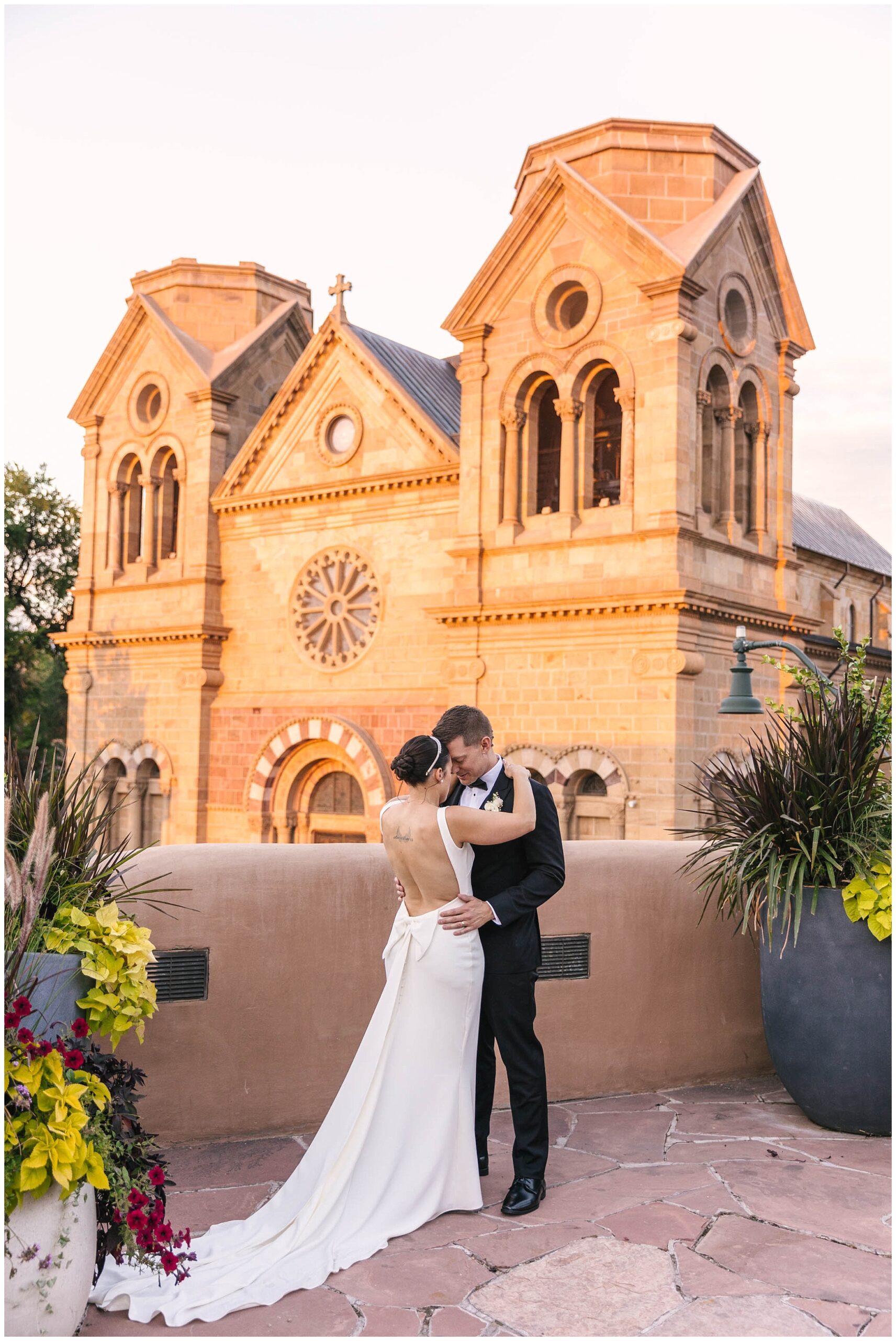 Sunset portraits of bride and groom at La Fonda on the Plaza wedding by Santa Fe Cathedral Basilica