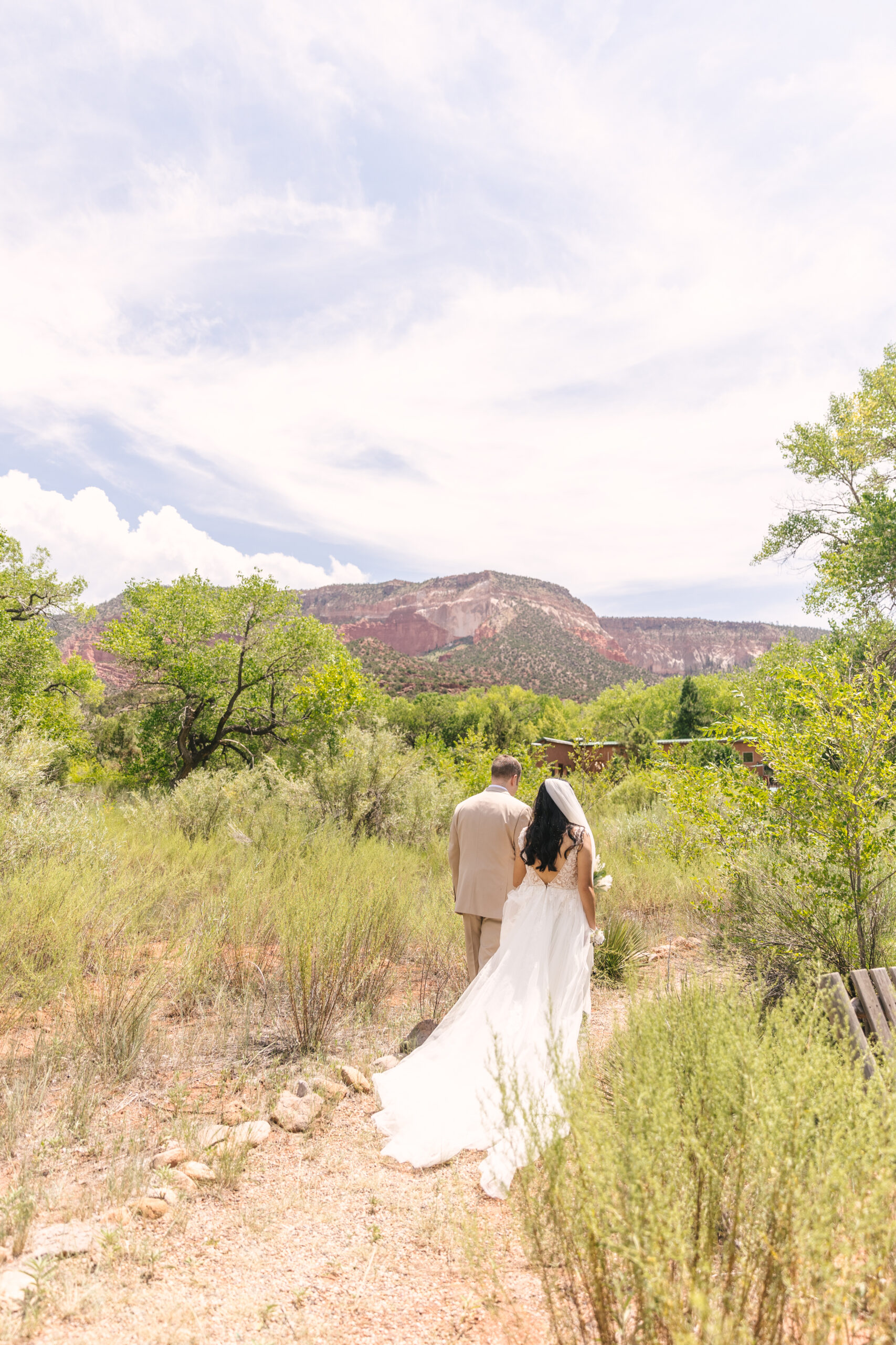 bride and groom walking near Jemez River after elopement at Canon del Rio inn