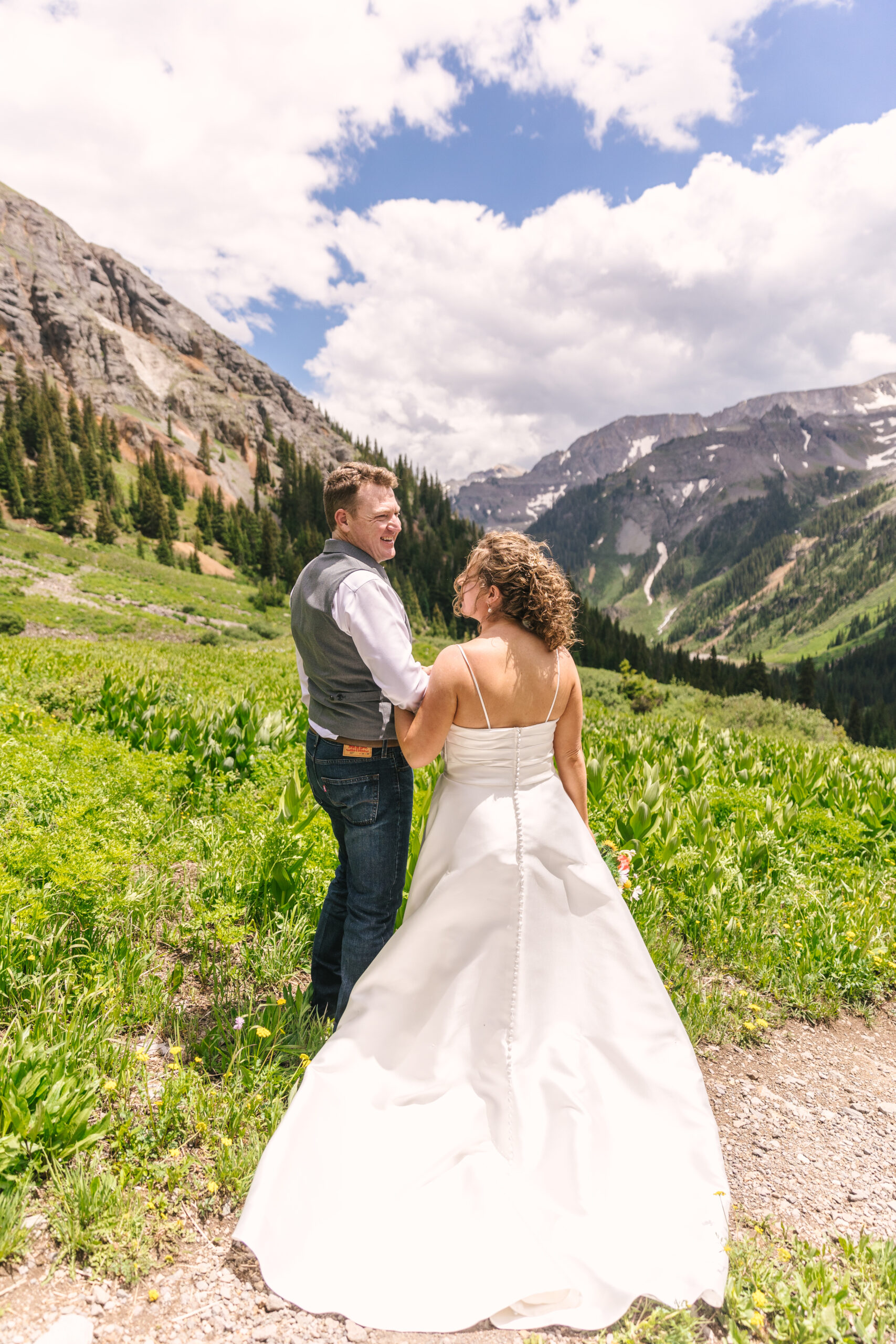 bride and groom facing the mountain views in Ouray Colorado