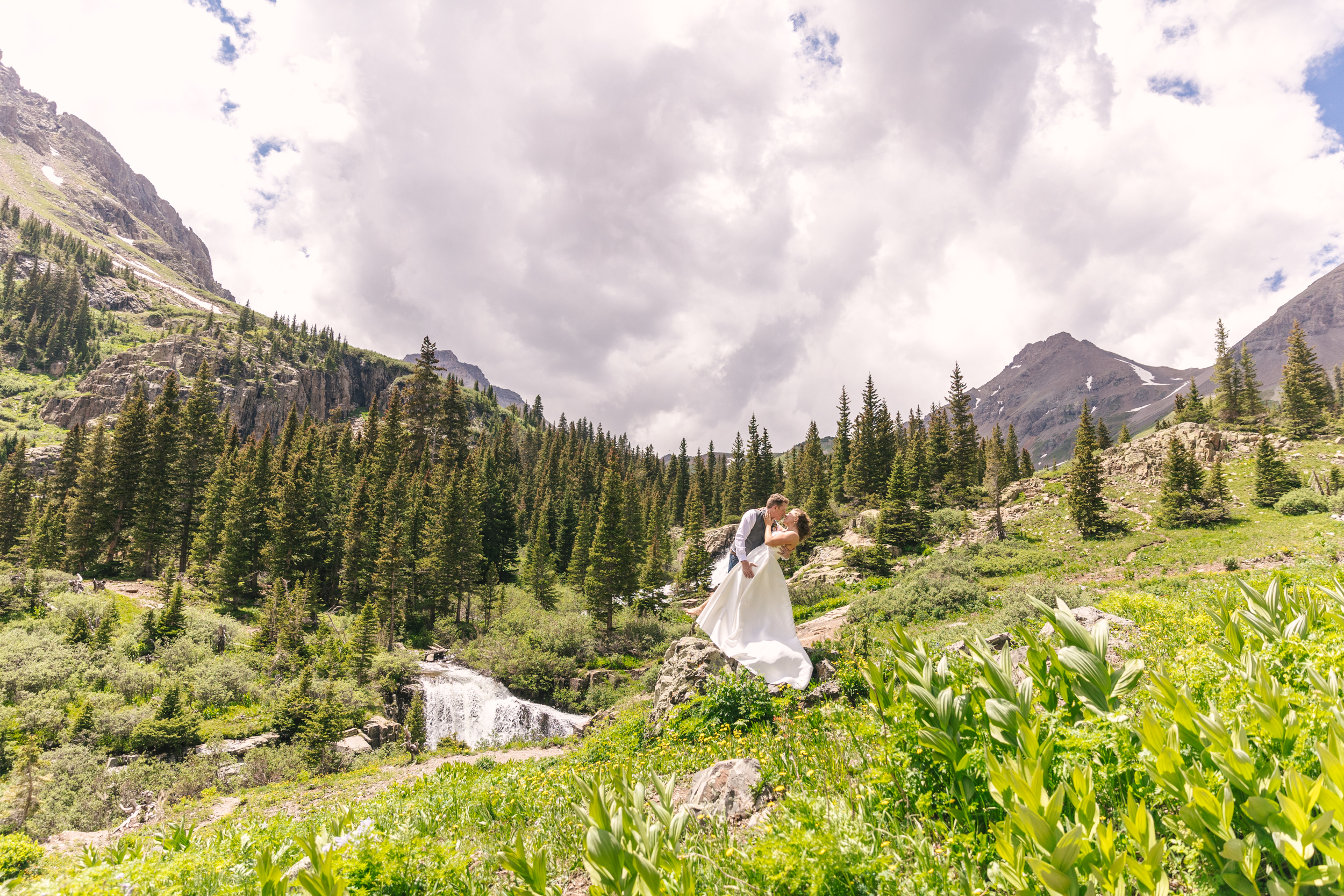 bride and groom kissing by waterfall in Ouray, Colorado
