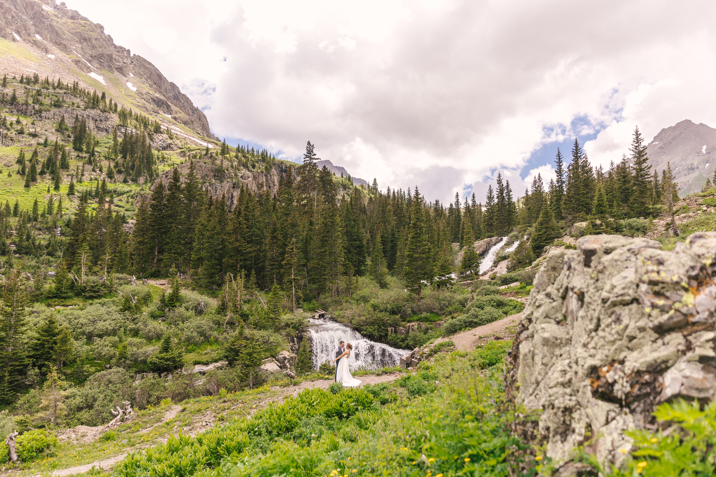 bride and groom dancing by waterfall in Ouray, Colorado
