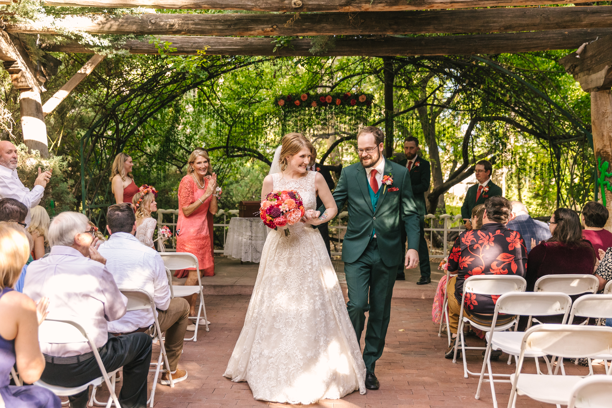 bride and groom exit their wedding ceremony at El Pinto Restaurant in Albuquerque