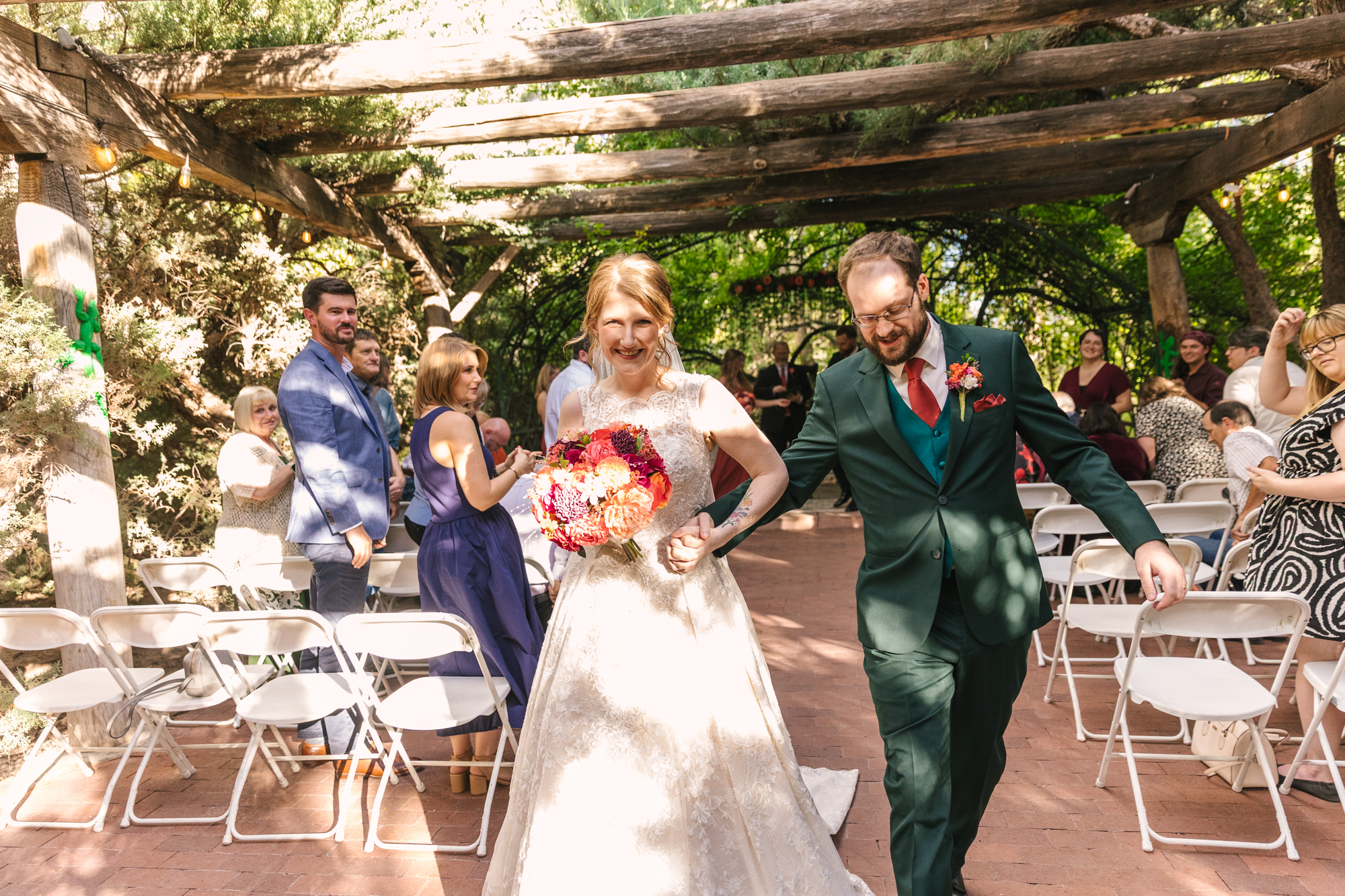 bride and groom exit their wedding ceremony at El Pinto Restaurant in Albuquerque
