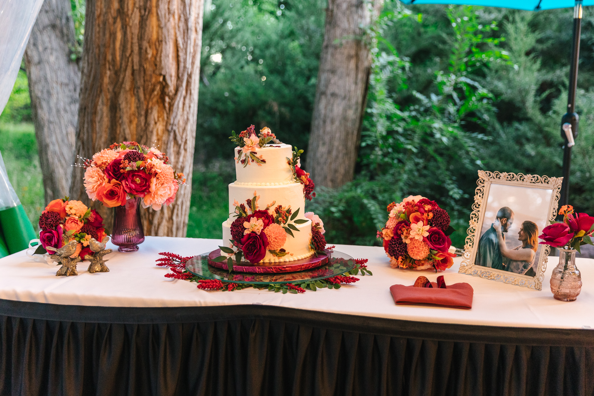 wedding cake with bright florals at El Pinto Restaurant