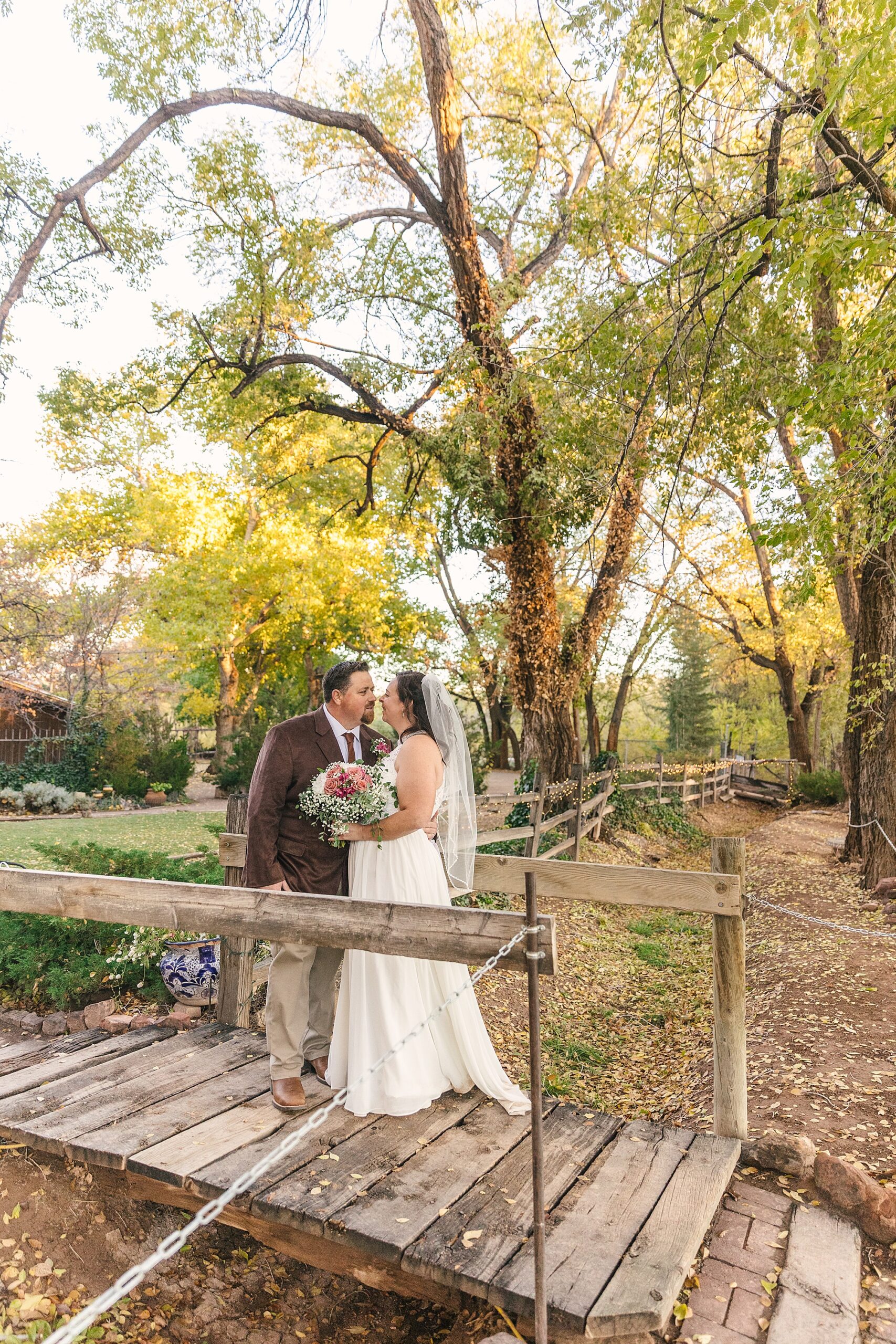 fall wedding couple portraits on the wooden bridge at Old Town Farm in Albuquerque