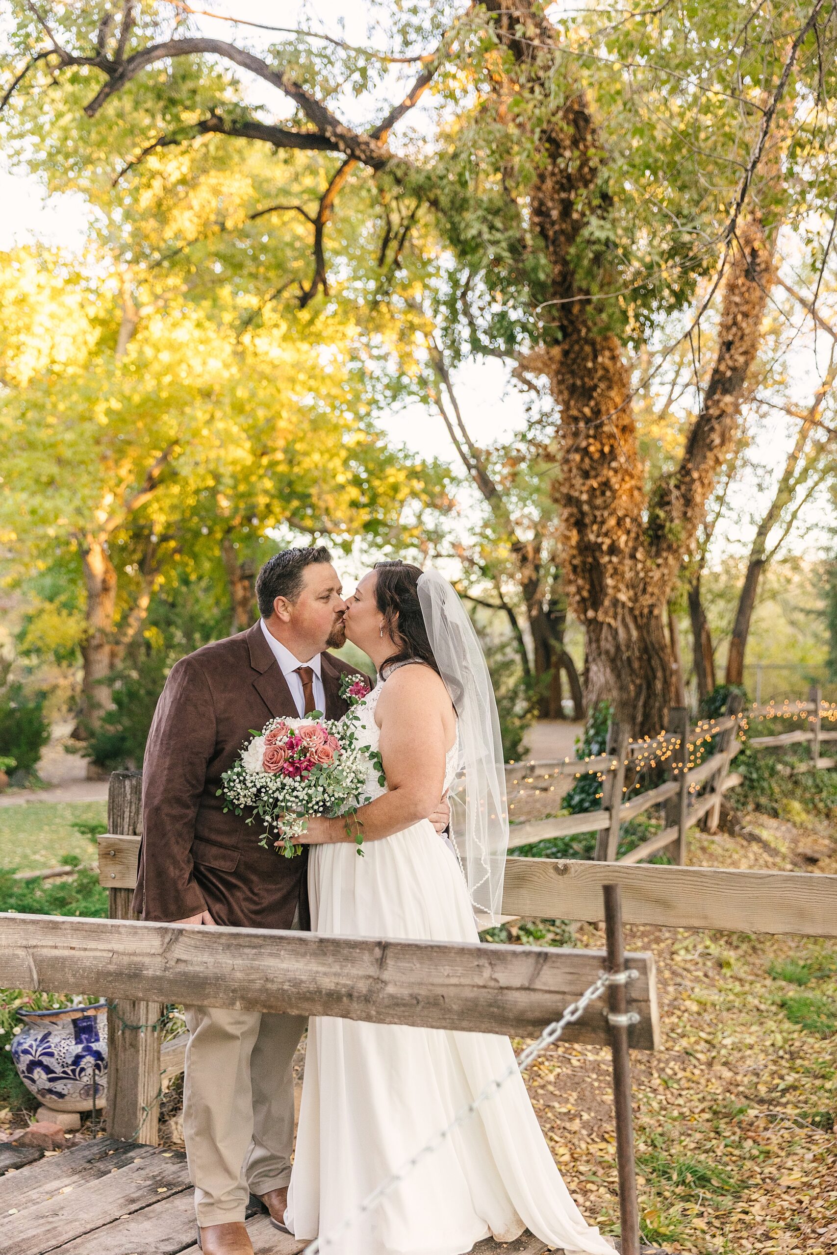fall wedding couple portraits on the wooden bridge at Old Town Farm in Albuquerque