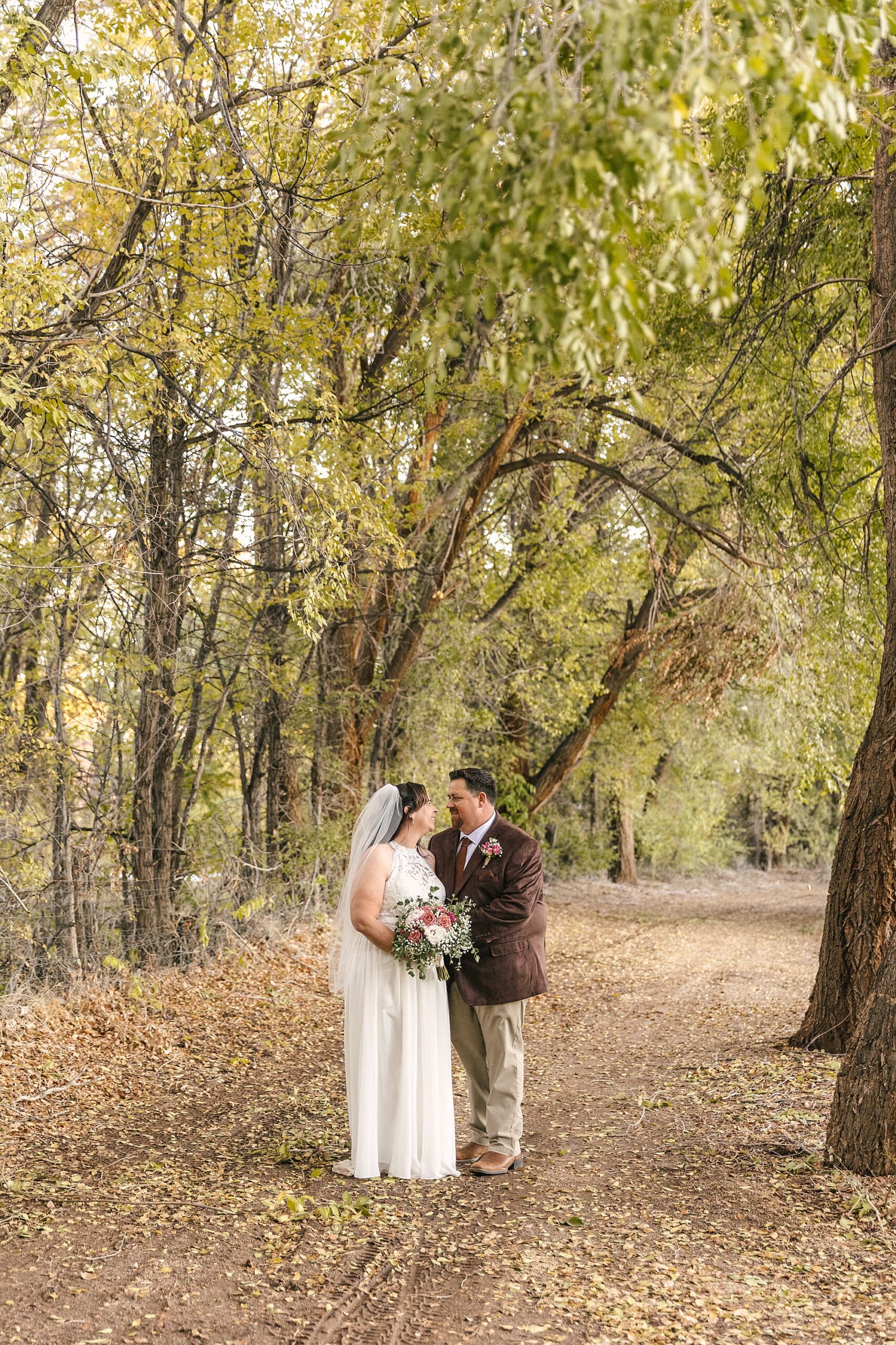 fall wedding portraits of bride and groom at Old Town Farm in Albuquerque
