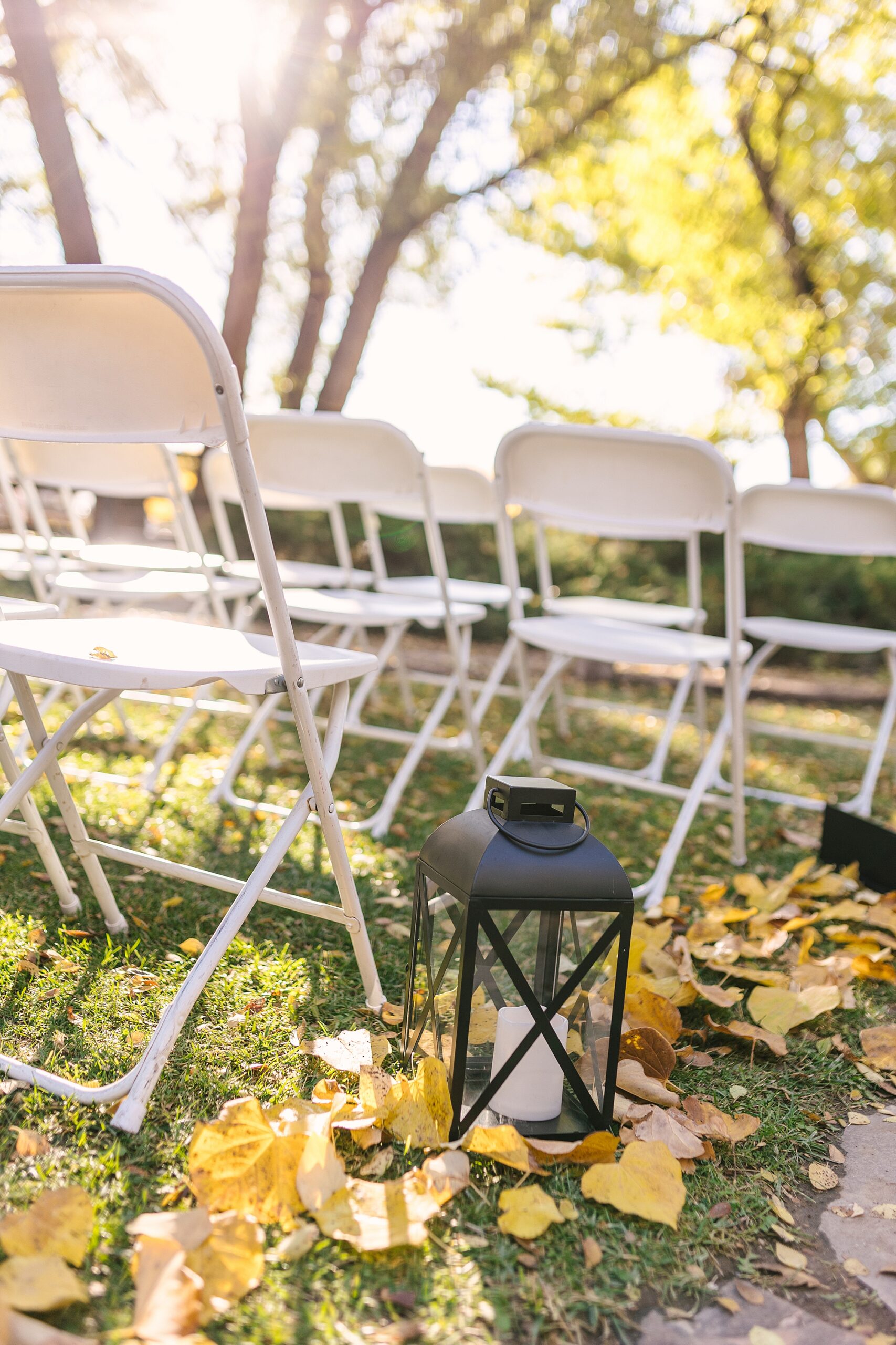 fall farm wedding details - lanterns in yellow leaves
