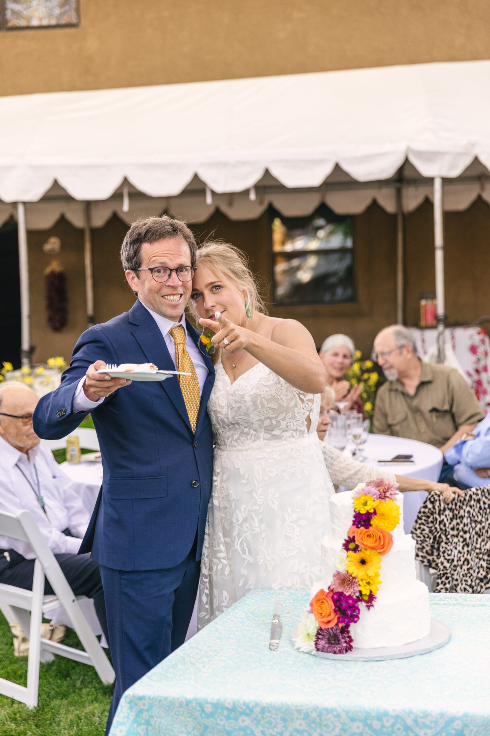 fun bride and groom candid after cutting the cake