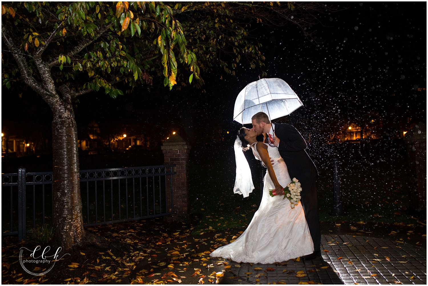 bride and groom on rainy night in Seattle