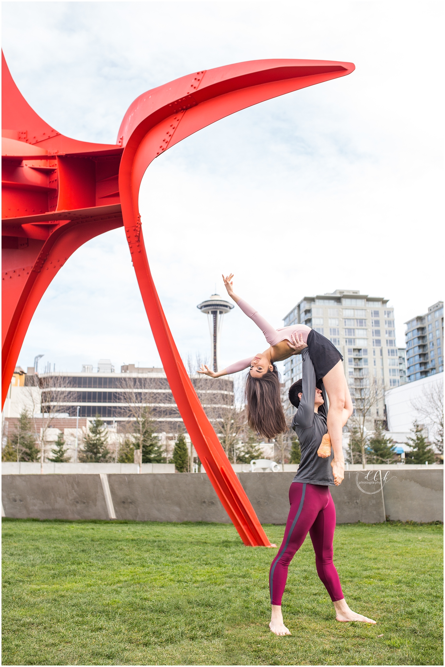 ballet partners dancing in front of Seattle Space Needle