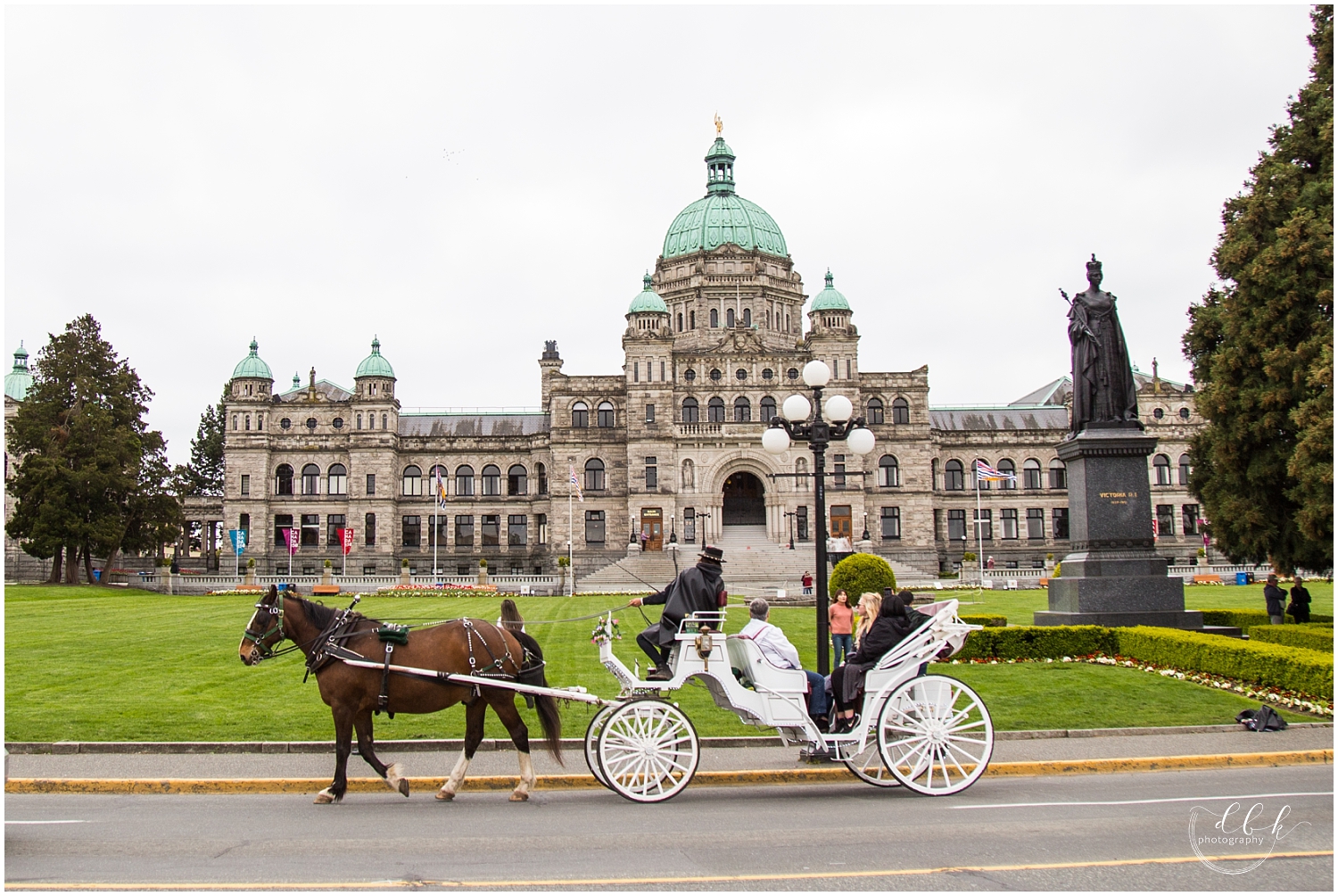 horse-drawn carriage passing the old British Columbia Parliament building in Victoria, BC