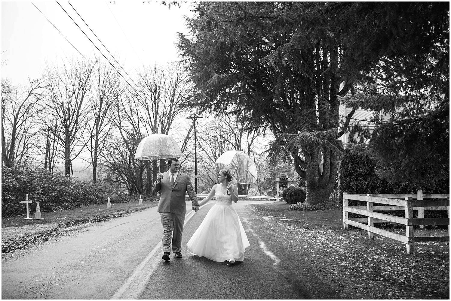 How to deal with rain on your wedding day: bride and groom with umbrellas.