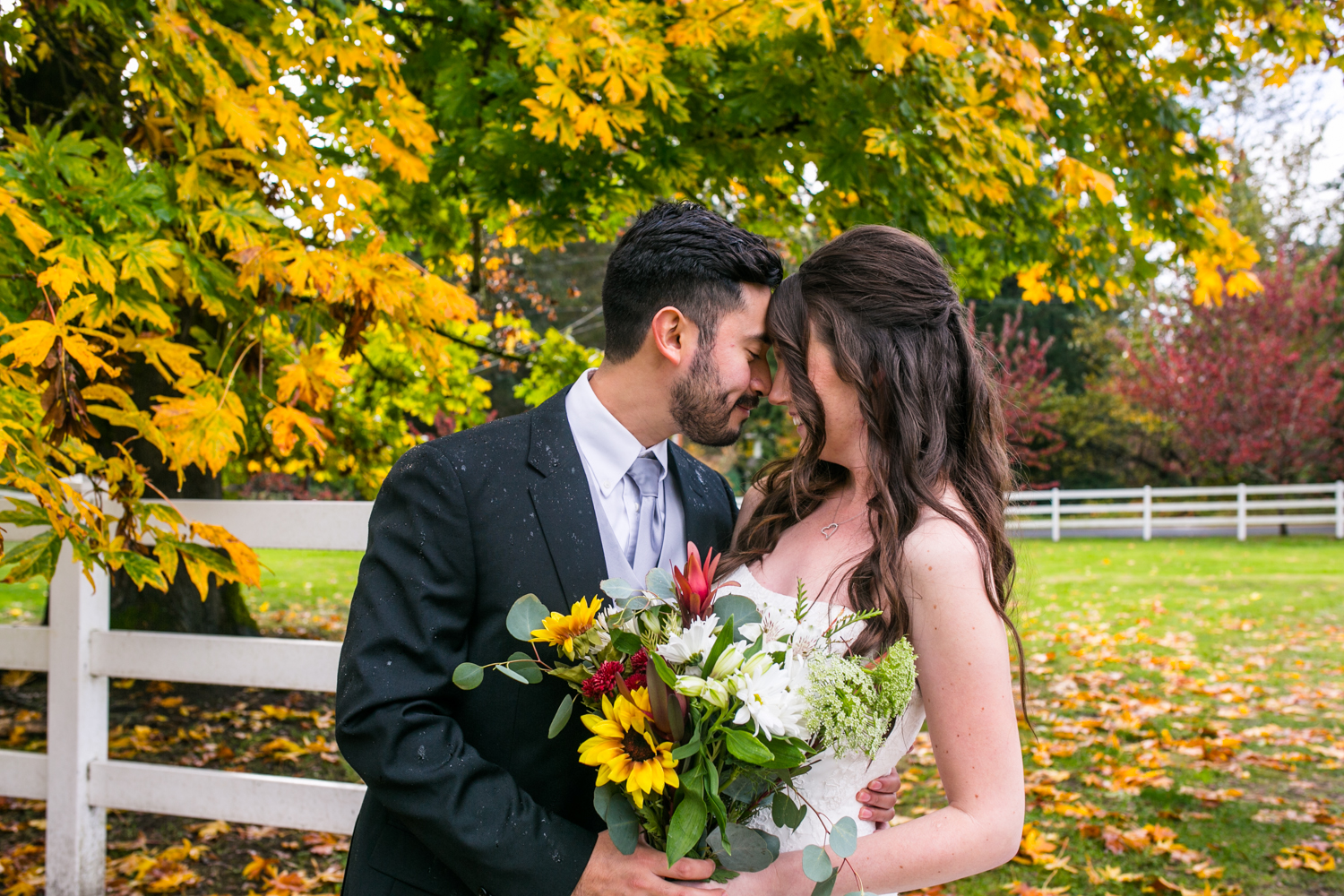 How to deal with rain on your wedding day: bride and groom during a break in the fall storm.