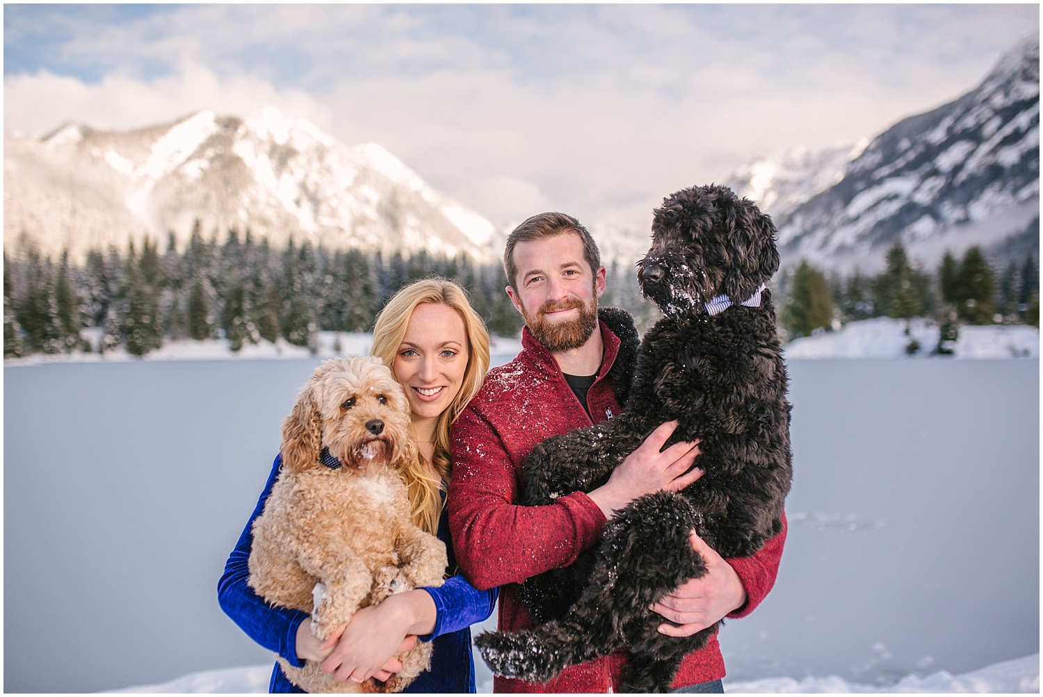 Snowy Winter Engagement Pictures at Snoqualmie Pass featuring two doodle mix dogs.
