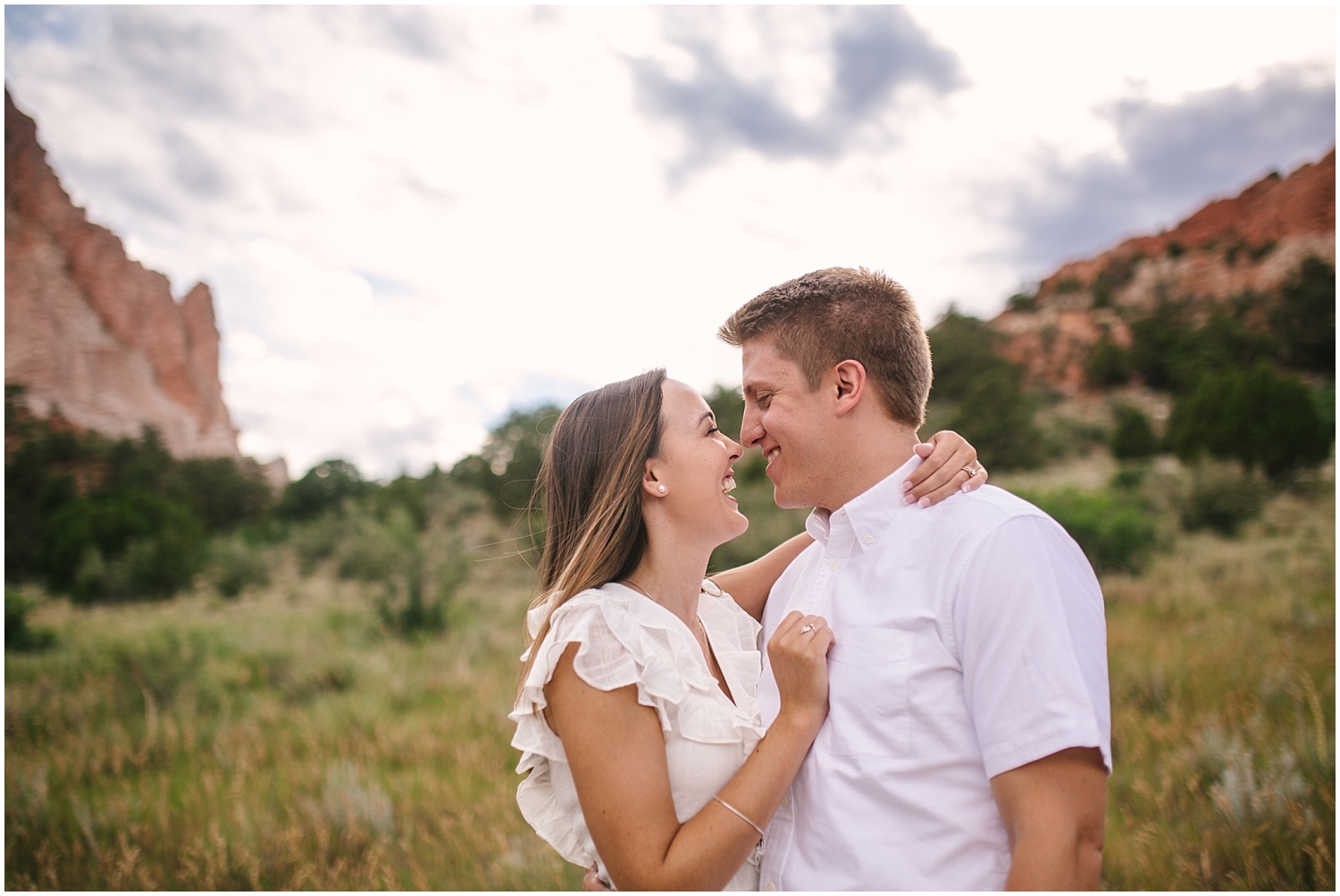 Couple in a field at Garden of the Gods for Colorado Springs engagement photos